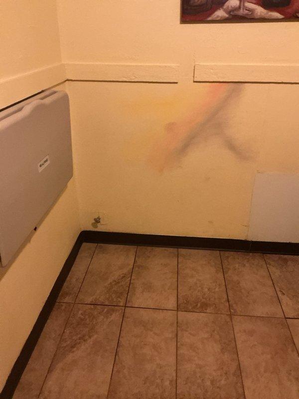 Responded to urgent water leak complaint at restaurant where water was flowing from building base. Upon inspection, discovered toilet leak in bathroom with accessible features. Repaired faulty toilet seal and inspected adjacent wall for water damage, noting minor staining that will require monitoring to ensure complete resolution of the issue.