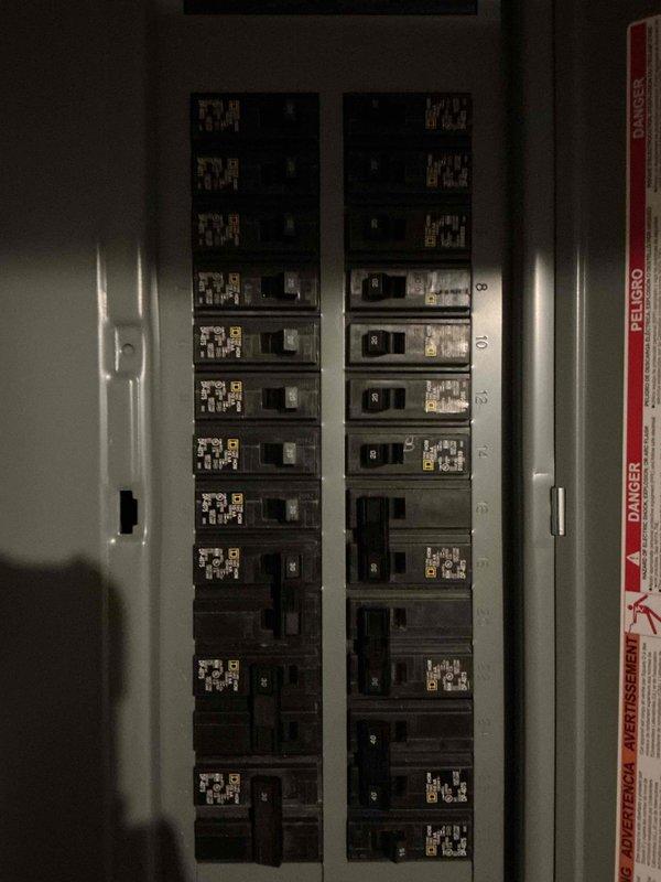 Completed panel replacement service (WO #15958), replacing outdated electrical panel with new circuit breaker panel featuring dual columns of properly labeled circuit breakers. Installation included proper mounting to concrete block wall with main breaker switch and comprehensive circuit directory for improved safety and functionality.