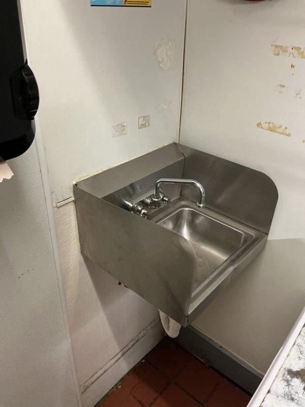 Successfully installed a commercial wall-mounted stainless steel handwashing sink with dual-handle faucet in corner location. Properly secured unit to wall with appropriate mounting hardware and connected water supply lines to existing plumbing system. Tested installation for proper function and water flow, ensuring no leaks at connection points.