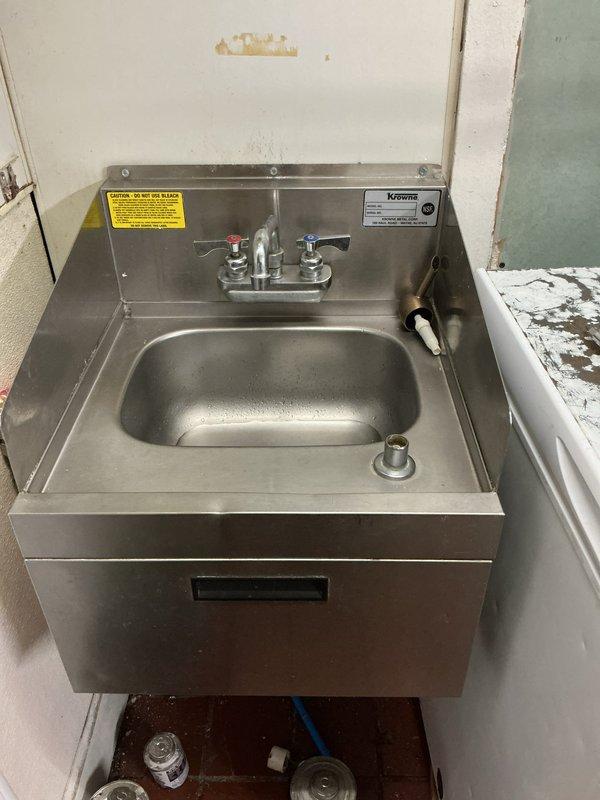 Successfully installed a commercial wall-mounted stainless steel handwashing sink with dual-handle faucet in corner location. Properly secured unit to wall with appropriate mounting hardware and connected water supply lines to existing plumbing system. Tested installation for proper function and water flow, ensuring no leaks at connection points.