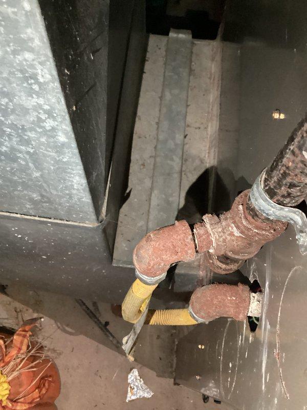 Performed comprehensive inspection of aging HVAC system showing significant copper line corrosion and oxidation at connection points. Documented deteriorated ductwork with improper insulation and noted measurements (20"x15" supply plenum) for replacement sizing. Recommended complete system replacement due to extensive corrosion damage and potential efficiency/safety concerns with current installation.