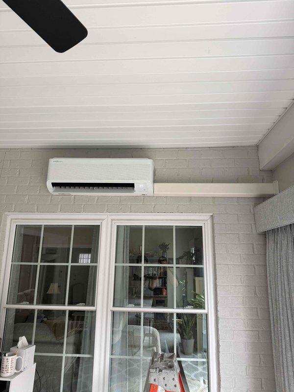 Successfully installed a 9000 BTU mini-split system in client's sunroom with 110V electrical connection. Unit was wall-mounted on white brick surface above windows, providing efficient cooling for the space. Verified proper electrical receptacle installation and system functionality before completing the job.