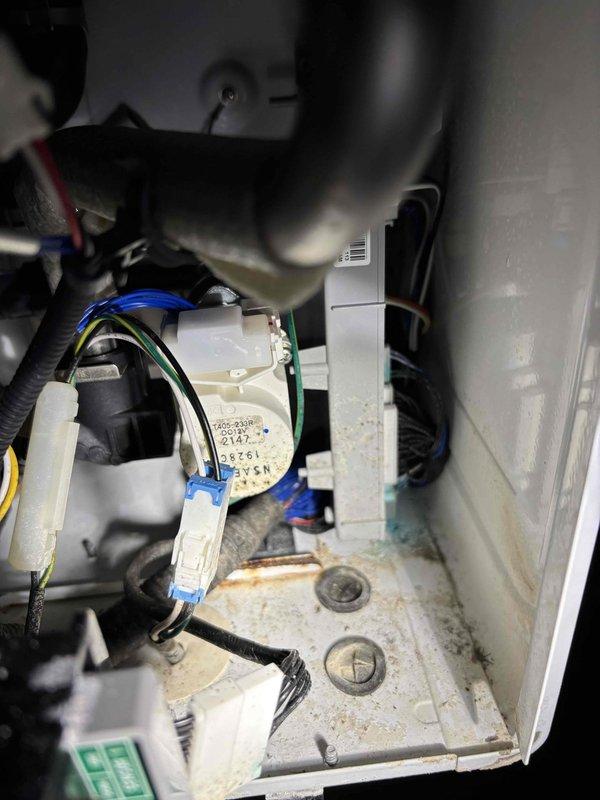 Performed warranty replacement of existing tankless water heater. Installed new unit on exterior wall with proper PVC venting and electrical connections. Internal inspection of previous unit revealed significant corrosion and rust damage on the bottom surface around drain points, likely contributing to failure. All connections were tested and system is functioning properly with no leaks detected.