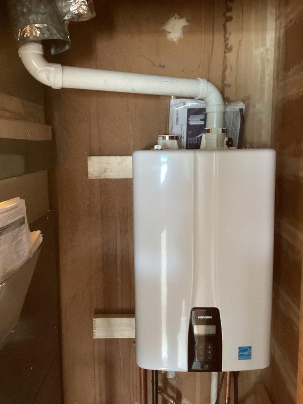 Successfully installed a Navien NPE-180A tankless water heater on a wooden wall with proper ventilation through PVC and metallic ducting. Installation included connecting copper, PVC, and drainage pipes to the unit and integrating it with an existing blue water filtration system in the utility room.