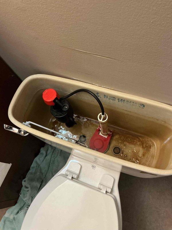 Replaced faulty water shutoff valve in toilet tank that was continuously running. Installed complete new flush kit, addressing mineral buildup and sediment accumulation in the tank. All components now functioning properly with proper water level restored.