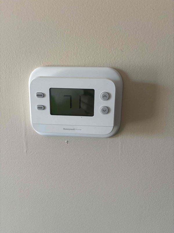 Completed installation of a full HVAC system for RED Cameron Service Finance customer. Installation included mounting a new Honeywell Home digital thermostat with proper wiring connections to the terminal block, ensuring all control wires (green, yellow, blue, and white) were correctly terminated at their designated ports. System was tested and confirmed to be operating at the proper temperature of 72 degrees.