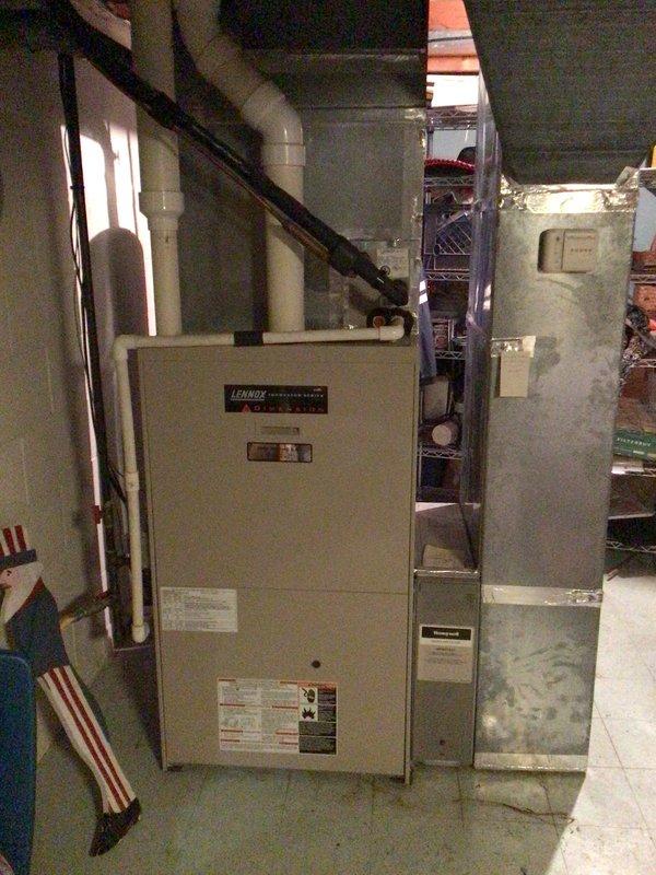 Responded to no-heat call for 15-year-old Lennox system (Model MNG32V5-125-1, Serial 5800B41474). Diagnosed faulty induction motor that was overheating and causing system shutdown; customer had correctly identified the issue as the motor was extremely hot to touch. Replaced motor and verified proper system operation with normal airflow through vents.