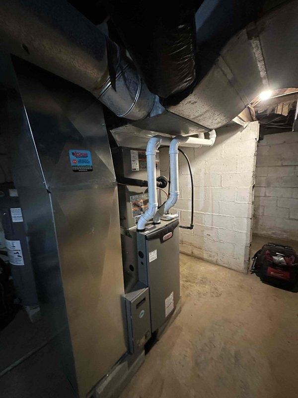 Successfully completed installation of a GREEN 17 SEER 97% efficiency complete HVAC system, including a high-efficiency furnace with PVC venting in the basement utility area and an outdoor condensing unit mounted on a concrete pad with proper electrical connections. All ductwork was properly installed and insulated, with the system fully tested and operational.