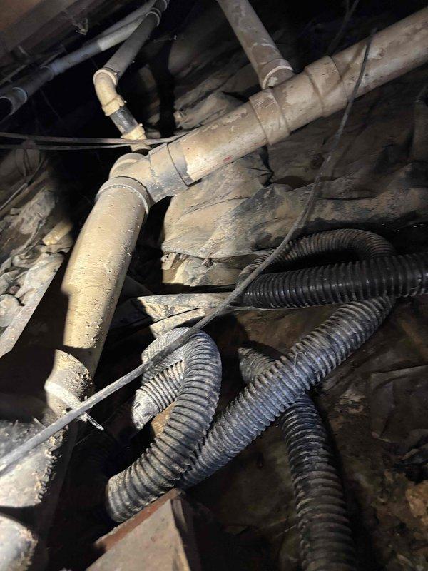 Conducted comprehensive inspection of residential plumbing system in crawlspace area, documenting PVC supply and drainage infrastructure. Identified aging pipes with accumulated grime and assessed structural supports connecting to floor joists. Estimate prepared for necessary repairs to maintain system integrity and prevent potential future failures.