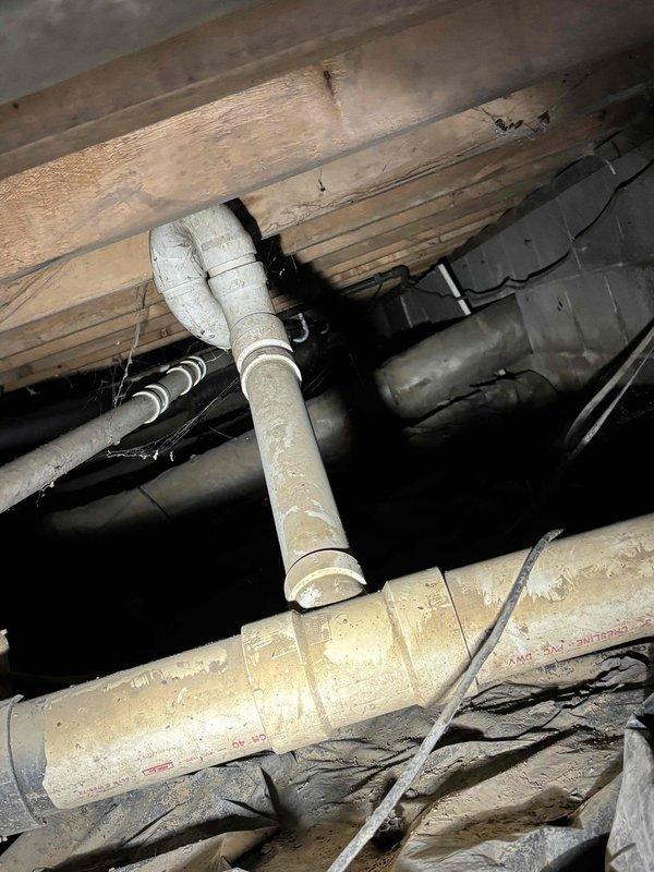 Conducted comprehensive inspection of residential plumbing system in crawlspace area, documenting PVC supply and drainage infrastructure. Identified aging pipes with accumulated grime and assessed structural supports connecting to floor joists. Estimate prepared for necessary repairs to maintain system integrity and prevent potential future failures.