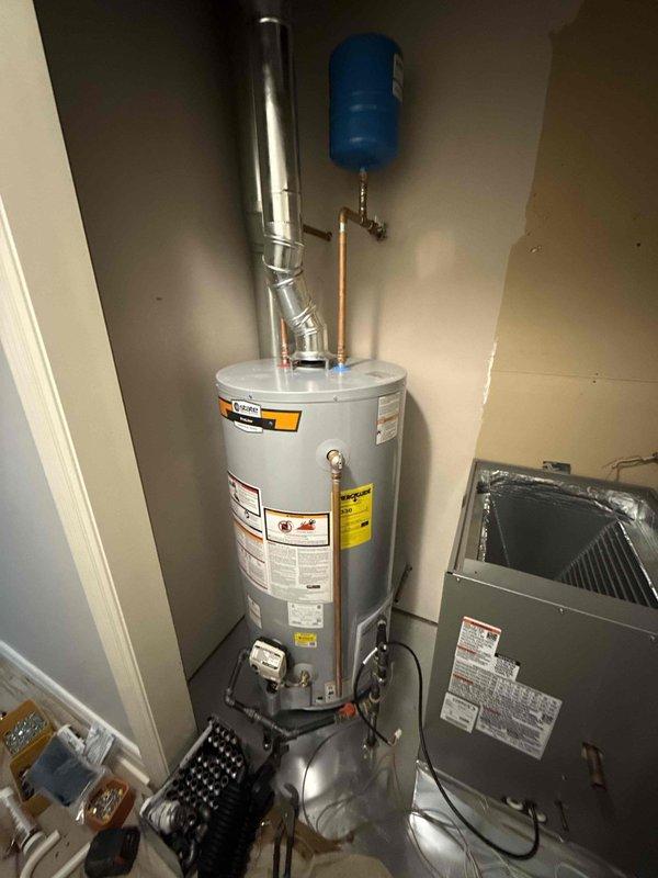 Successfully installed a new 50-gallon short yellow gas water heater with proper venting and copper connections. Mounted a blue expansion tank to the wall and ensured all piping was correctly fitted. System was tested and verified to be functioning correctly with no leaks detected.