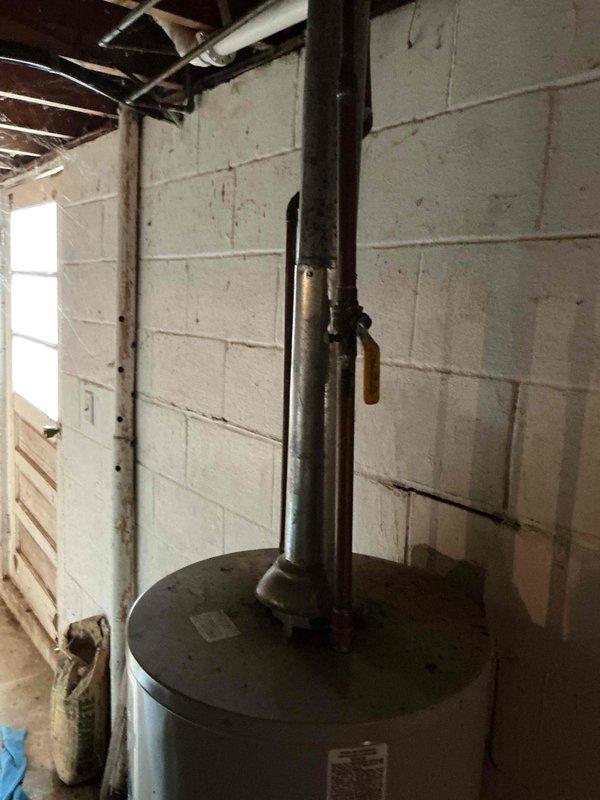 Diagnosed and replaced leaking 40-gallon gas water heater in basement mechanical room. Installed new unit with proper ventilation and connection to existing copper supply lines. Verified proper operation with no leaks at connection points and confirmed appropriate gas pressure and water temperature.