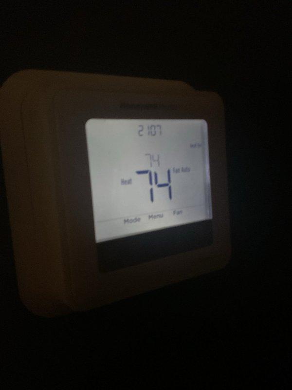 Responded to service callback for heating system that has been non-operational since previous part replacement. Inspected thermostat settings, which was displaying 74°F and set to Heat mode with Fan Auto. Verified proper thermostat operation and corrected system functionality, confirming heat production and normal operation before departing.