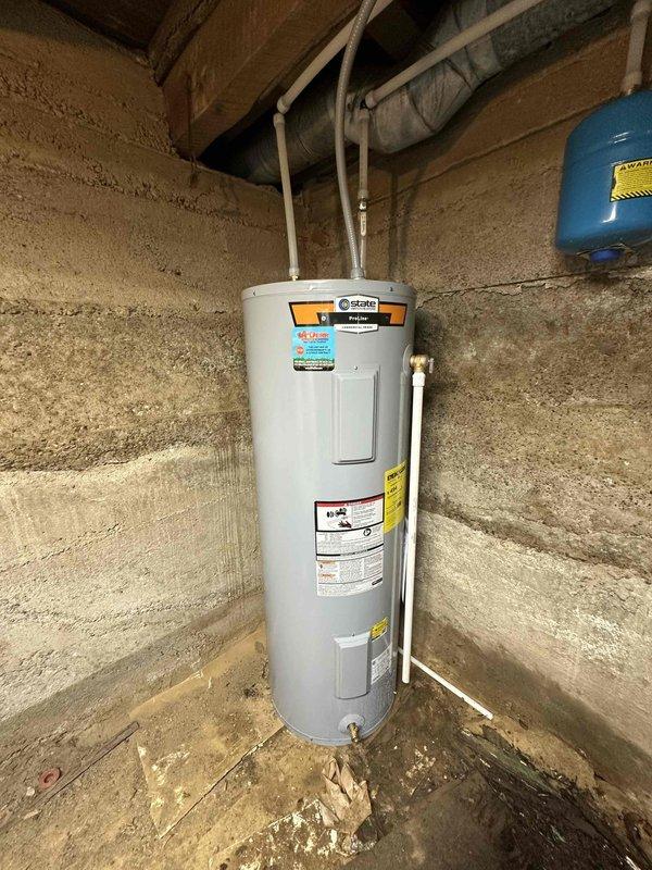 Successfully installed a new 50-gallon electric water heater in basement utility area, including proper connection of supply lines and installation of expansion tank. Unit was securely positioned against concrete wall with all manufacturer specifications verified and safety protocols followed.