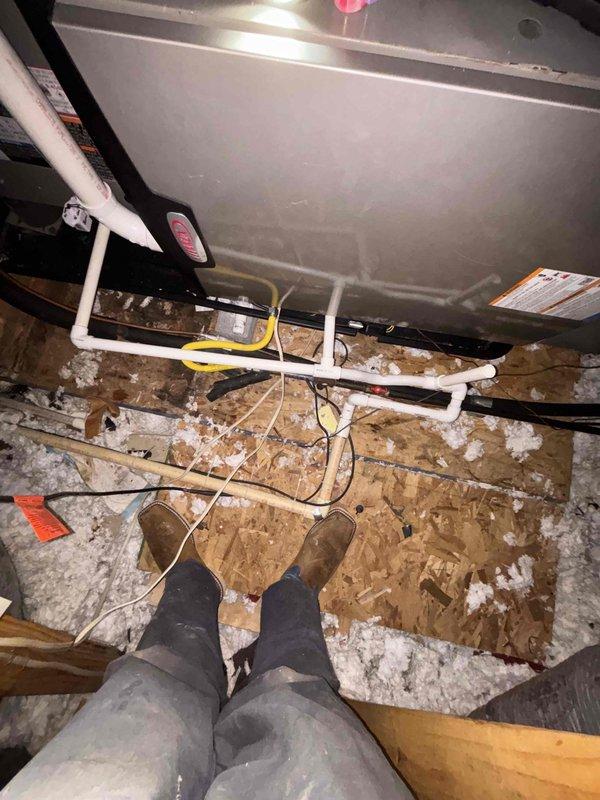 Completed adjustment of evaporator coil positioning as specified in previous inspection. Verified proper level and alignment using spirit level during installation. Ensured proper connection of PVC condensate lines and electrical wiring to the air handler unit in attic space.