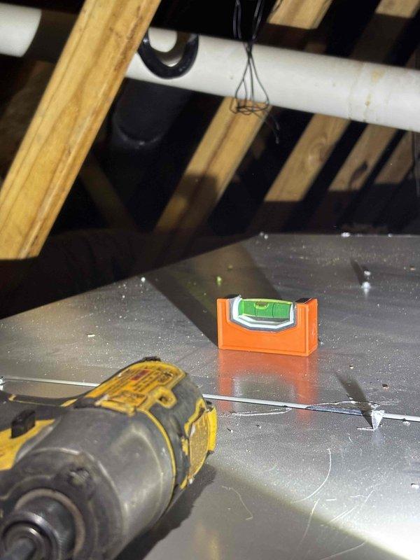 Completed adjustment of evaporator coil positioning as specified in previous inspection. Verified proper level and alignment using spirit level during installation. Ensured proper connection of PVC condensate lines and electrical wiring to the air handler unit in attic space.