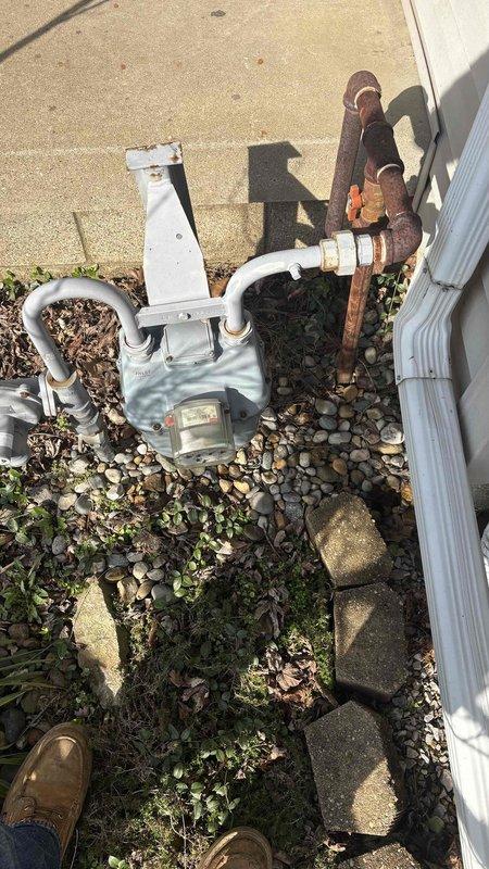 Conducted a generator installation estimate at residential property, noting severely corroded gas piping that will require replacement prior to generator installation. Observed existing gas meter configuration and documented current plumbing conditions to incorporate necessary repairs into comprehensive generator installation proposal.