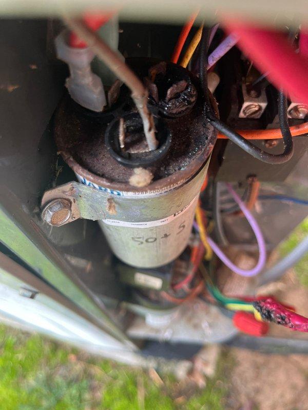Performed scheduled maintenance on American Standard HVAC system. Identified significant corrosion on capacitor terminals with multiple wiring connections showing wear. System includes furnace unit with proper ductwork, PVC ventilation pipes, and gas line connection; all components were inspected and are in functional condition.