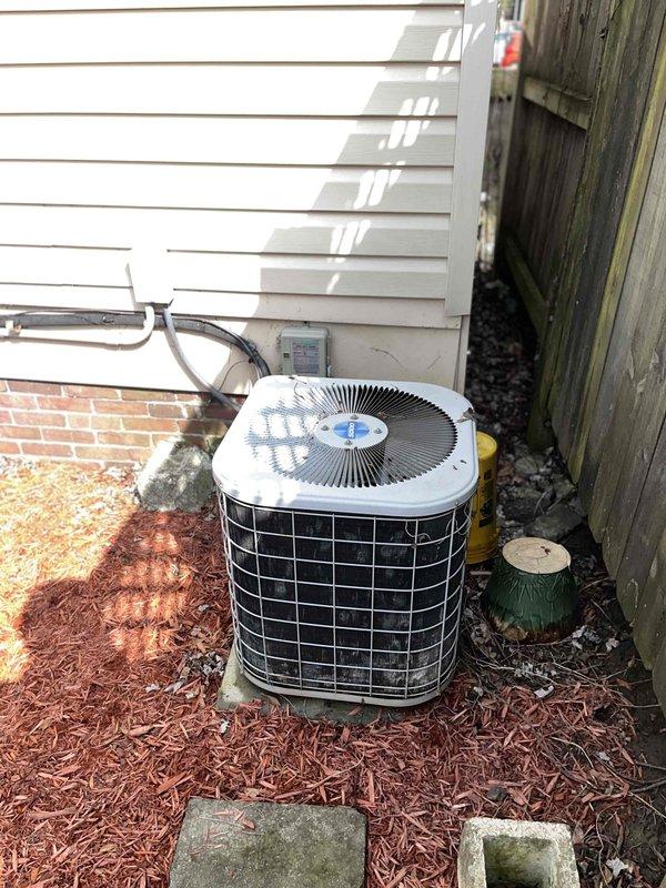 Conducted comprehensive assessment of existing HVAC system for potential replacement. Inspection revealed significant weathering and corrosion on exterior electrical panel with visible rust and deterioration of metal housing. Outdoor AC condenser unit examination showed aging equipment mounted on concrete pad requiring upgrade to improve energy efficiency and system reliability.