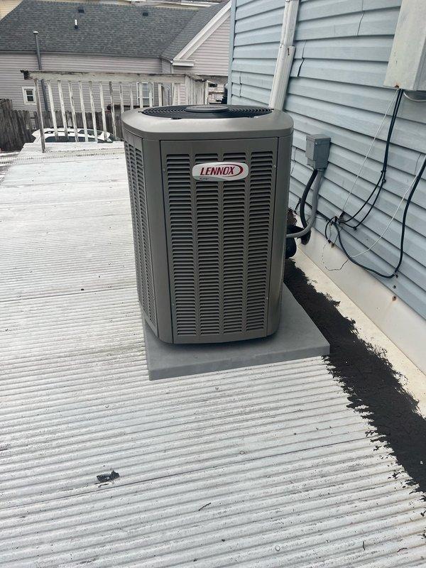 Performed monthly platinum-level maintenance service on a 2-year-old Lennox HVAC system. Replaced 20x20x5 filter according to maintenance schedule. Visual inspection of the roof-mounted outdoor condenser unit confirmed proper installation on concrete pad with no visible damage or abnormal conditions; unit specifications and performance parameters were documented with photos for service record.