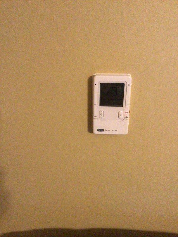 Performed Gold Level annual maintenance on a 14-year-old Carrier HVAC system. Inspected outdoor condenser unit (mounted on concrete pad against brick wall) and verified thermostat operation. Replaced 20x25x5 air filter as part of scheduled first visit service.