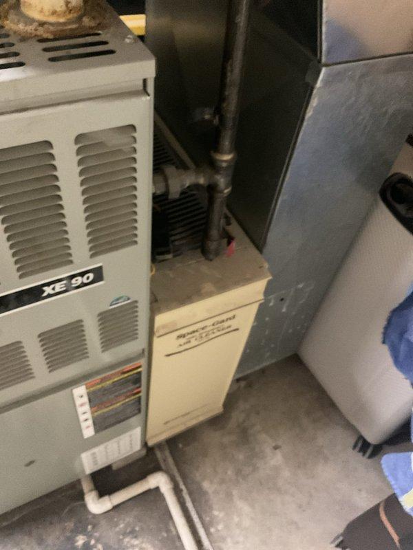Replaced 15+ year old inoperative heating system with new XE 90 furnace installation in basement utility area. Complete system replacement included new ductwork connections, PVC venting, and integration with existing humidifier. Installation verified proper function of all components with comprehensive testing of the new heating system.