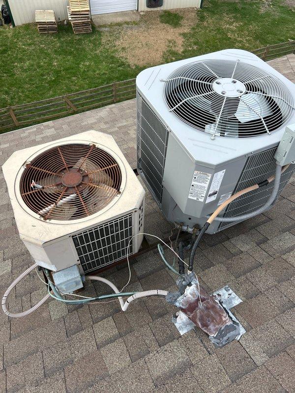 Conducted an estimate for replacement of an aging R22 system experiencing refrigerant leak. Visual inspection revealed two rooftop units with significant wear on the older beige unit, including visible rust on fan components and deteriorated condition compared to the newer gray unit. Recommended full system replacement due to R22 phase-out and current system's non-operational status.