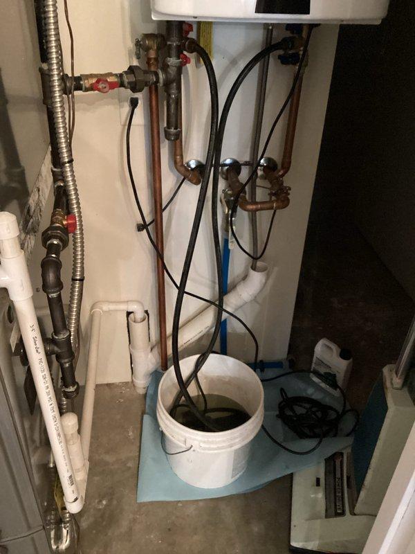 Successfully completed a scheduled maintenance flush on a Navien tankless water heater system to remove mineral buildup and sediment. Performed a thorough flush of the heat exchanger using appropriate descaling solution, ensuring proper flow through all components and collecting discharge in containment vessel. System was properly reassembled, tested for operation, and returned to service in optimal working condition.