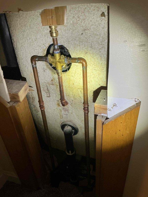 Responded to service call for a broken ball valve after customer attempted to replace mixer assembly. Upon inspection, found damaged brass mixing valve with copper supply lines in bathroom fixture wall. Successfully replaced the damaged valve assembly and verified proper water flow with no leaks in the completed installation.