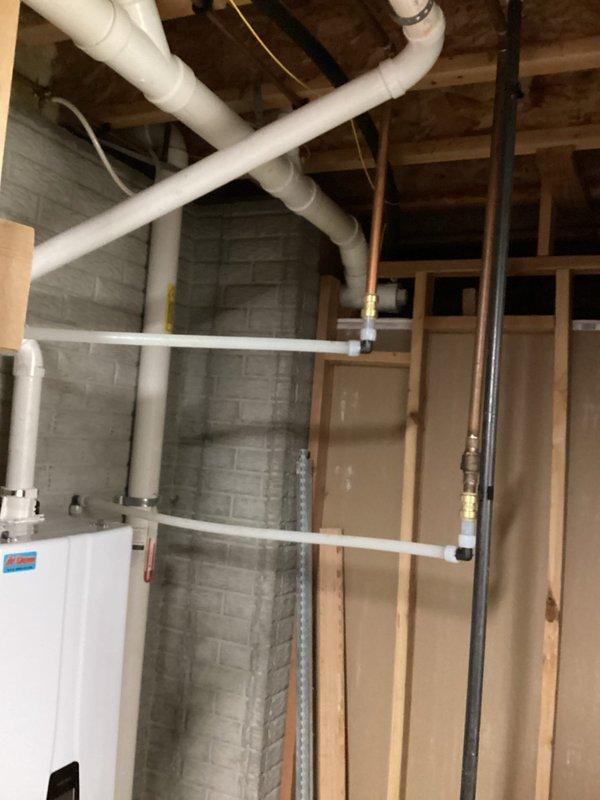 Inspected drainage issue where waste water was improperly draining into sump pump basin. Evaluated existing plumbing configuration in basement, including PVC waste lines and connections. Removed switch component from tankless water heater system for replacement as requested.