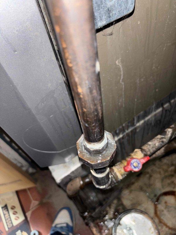Responded to a gas leak call for a 2010 HVAC system. Upon inspection, identified corrosion at pipe joint connections in the utility room, with visible signs of moisture and deterioration at the copper pipe and fitting assembly. Repaired the faulty connection point that was causing the intermittent gas odor detectable upon entering the room.
