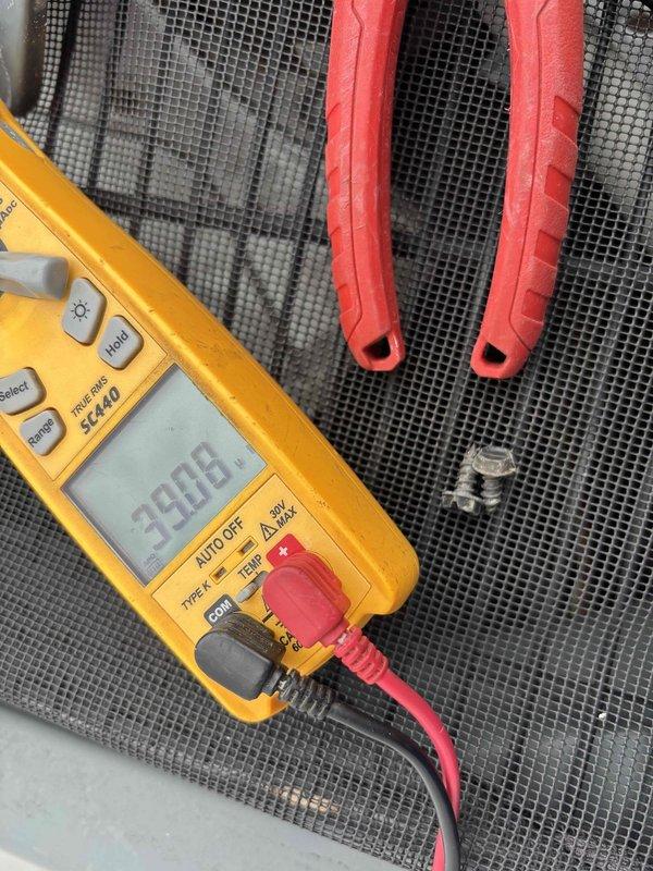 Performed planned maintenance on 9-year-old HVAC system. Conducted electrical measurements with Fluke 5440 multimeter showing 3808 reading and temperature verification with digital thermometer (-50°C to 300°C range). System functioning properly after service; customer has Gold Level maintenance agreement with next scheduled visit in 4/2025.