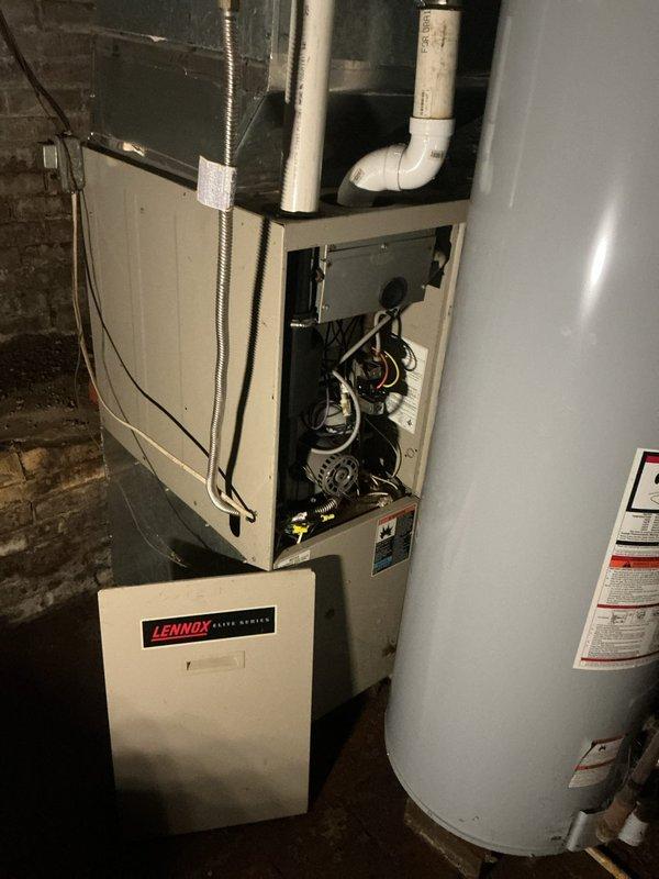Responded to no-heat call for 15-20 year old Lennox Elite Series furnace located in damp basement environment. Upon inspection, discovered severely rusted blower motor assembly consistent with prolonged moisture exposure, preventing proper system operation. Replaced blower motor assembly, tested all connections, and verified complete system functionality with proper heating output restored.