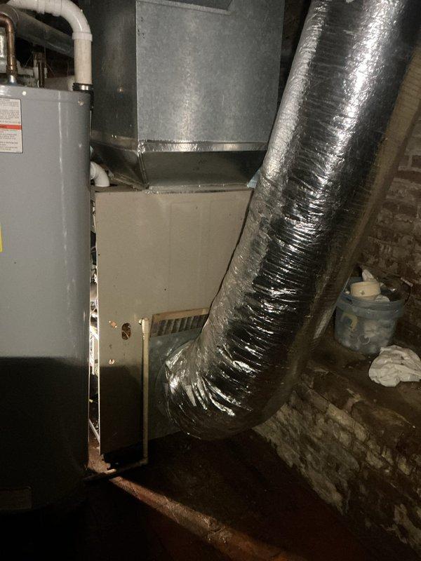 Responded to no-heat call for 15-20 year old Lennox Elite Series furnace located in damp basement environment. Upon inspection, discovered severely rusted blower motor assembly consistent with prolonged moisture exposure, preventing proper system operation. Replaced blower motor assembly, tested all connections, and verified complete system functionality with proper heating output restored.