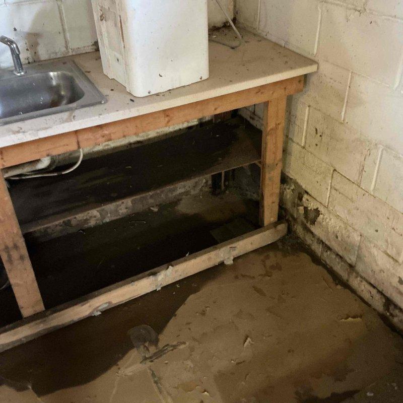 Conducted site assessment at church property experiencing flooding during heavy rainfall events. Inspection revealed deteriorated utility area with moisture damage to concrete block walls and a drainage basin with standing water. Recommended installation of additional sump pump system to improve water management and prevent recurring flooding issues.