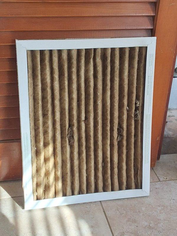 Performed diagnostic inspection on HVAC system in response to ceiling water leak occurring during system operation. Identified damaged and clogged air filter with multiple tears causing condensate drainage issues. Replaced filter, cleaned drain line, and verified proper system operation with no further leakage.