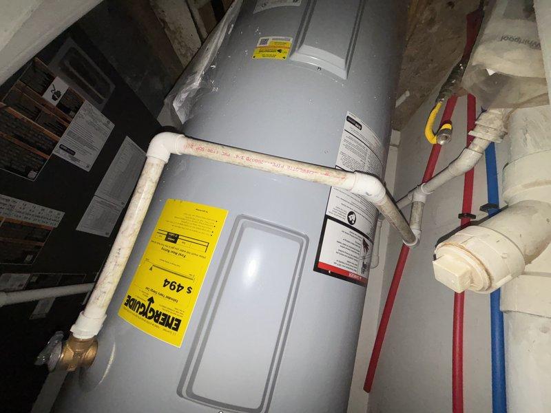 Successfully completed water heater installation in basement utility area, connecting all required PVC piping and properly setting up color-coded hot/cold water lines. Verified proper connection of drain pipes and confirmed unit was functioning according to manufacturer specifications.