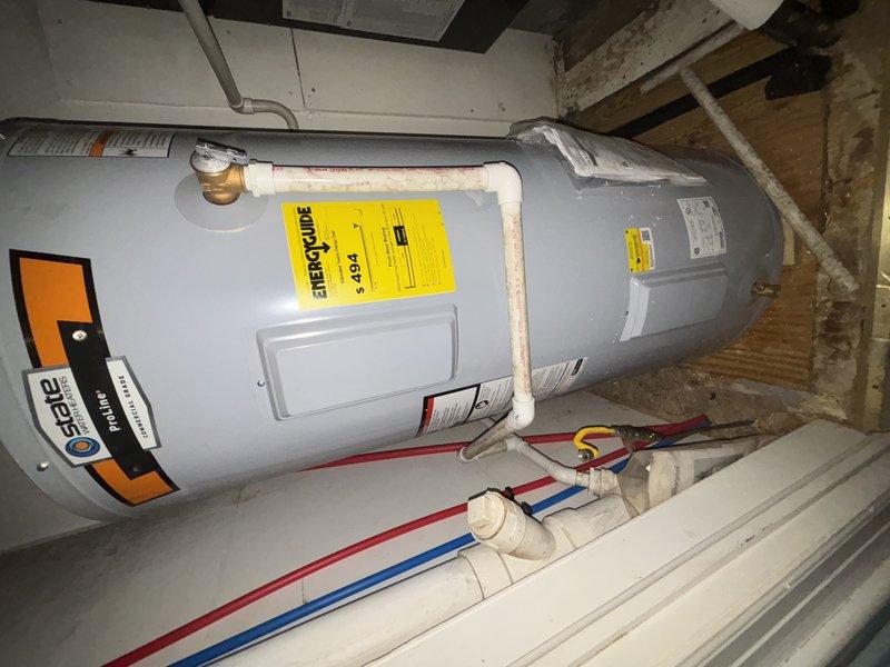 Successfully completed water heater installation in basement utility area, connecting all required PVC piping and properly setting up color-coded hot/cold water lines. Verified proper connection of drain pipes and confirmed unit was functioning according to manufacturer specifications.