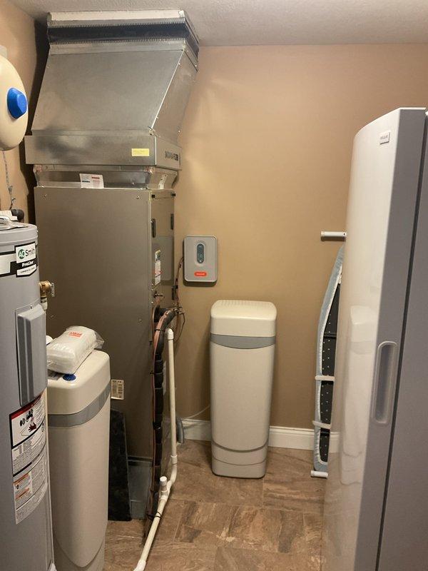 Completed planned maintenance on an 8-year-old HVAC system under Platinum Level service agreement (first annual visit). Replaced 24x24x4 filter and documented significant corrosion with moisture accumulation at panel seams, indicating potential refrigerant leakage. Inspected utility room configuration including water treatment systems and associated ductwork to ensure proper system operation.