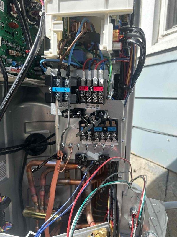 Successfully installed a 20K BTU dual-zone mini-split system with both 110V/220V electrical circuits at the customer's residence. The outdoor condenser unit was properly mounted on a concrete pad with protected refrigerant and electrical lines running to the building, and all interior wiring was completed with appropriate terminal connections and color-coded wiring to ensure optimal system functionality.