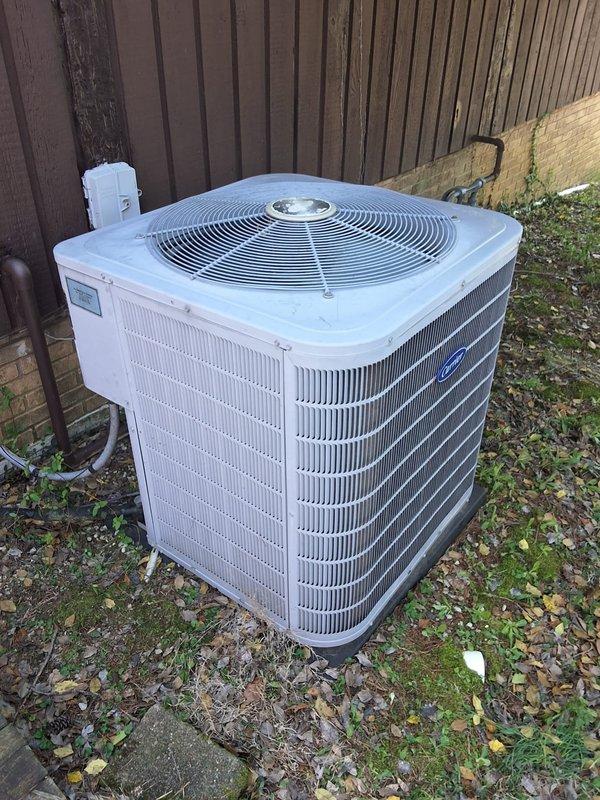 # Service Call Back - A+ Summary

Returned to property for callback on system issue that persisted after initial service visit. Upon arrival, performed comprehensive diagnostic evaluation of outdoor condensing unit. Condenser unit located on ground-level installation adjacent to privacy fence with electrical disconnect properly positioned. Unit showed signs of environmental debris accumulation including leaves, wood chips, and vegetation growth around base perimeter.

Conducted thorough inspection of condenser coils, fan motor assembly, and electrical components. Verified proper airflow through heat exchanger fins and assessed overall unit operation. Documented current system conditions with photographic evidence showing condenser placement, coil configuration, and surrounding environmental factors. Unit positioned on concrete pad with adequate clearance for service access.

Following diagnostic procedures, identified root cause of ongoing system malfunction. Presented repair recommend
