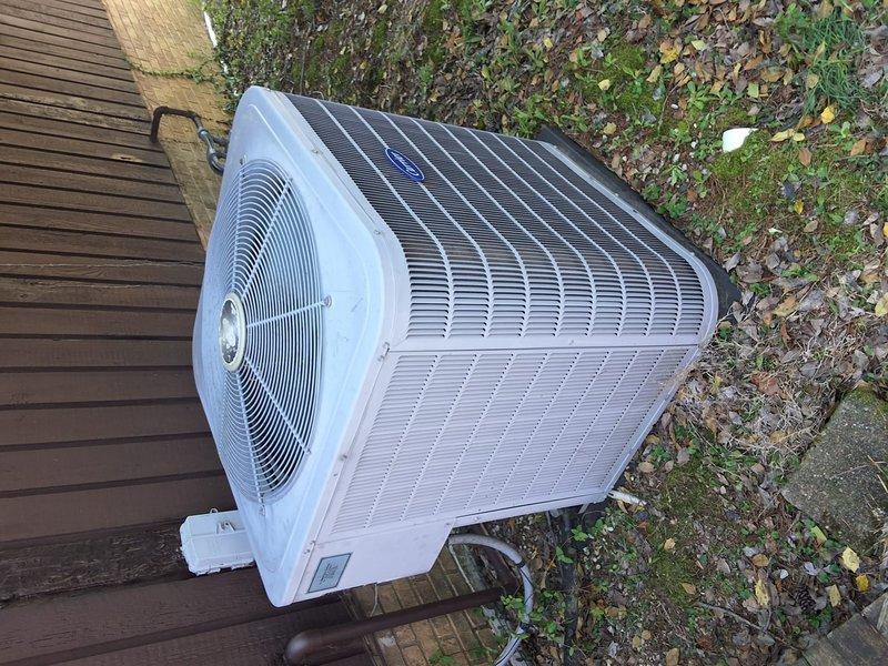 # Service Call Back - A+ Summary

Returned to property for callback on system issue that persisted after initial service visit. Upon arrival, performed comprehensive diagnostic evaluation of outdoor condensing unit. Condenser unit located on ground-level installation adjacent to privacy fence with electrical disconnect properly positioned. Unit showed signs of environmental debris accumulation including leaves, wood chips, and vegetation growth around base perimeter.

Conducted thorough inspection of condenser coils, fan motor assembly, and electrical components. Verified proper airflow through heat exchanger fins and assessed overall unit operation. Documented current system conditions with photographic evidence showing condenser placement, coil configuration, and surrounding environmental factors. Unit positioned on concrete pad with adequate clearance for service access.

Following diagnostic procedures, identified root cause of ongoing system malfunction. Presented repair recommend