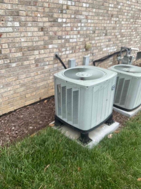 # HVAC Replacement Estimate Summary

Conducted comprehensive on-site evaluation for complete HVAC system replacement at residential property. Homeowner requested estimate for aging but functional system as proactive replacement measure. Assessed existing dual outdoor condenser units positioned on concrete pads along exterior brick wall and indoor American Standard air handling equipment. Documented current equipment specifications, measured existing unit dimensions, evaluated ductwork connections including flexible gray corrugated runs, and photographed installation configurations. Provided detailed replacement options and system sizing recommendations based on current equipment layout and home comfort requirements. Estimated appointment duration completed within standard 1 to 1.5 hour timeframe.