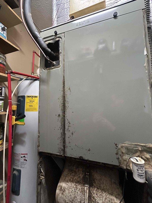 # Service Report

Responded to no-cooling complaint on 15-year-old residential HVAC system. Customer reported outdoor condensing unit not operating while indoor blower ran continuously, producing room temperature air with thermostat set to 68°F showing 75°F indoor temperature.

Upon arrival, confirmed outdoor unit failed to energize when thermostat called for cooling. Verified no tripped breakers at electrical panel. Inspected indoor air handler and found evaporator coil heavily contaminated with dust and debris accumulation, significantly restricting airflow. Drip pan showed extensive dirt buildup and deterioration. System components displayed poor maintenance history with substantial neglect evident throughout.

Performed diagnostic testing on outdoor condensing unit electrical components. Identified failed contactor preventing compressor and condenser fan motor operation. Tested capacitor values and found dual run capacitor reading out of specification, indicating capacitor failure 