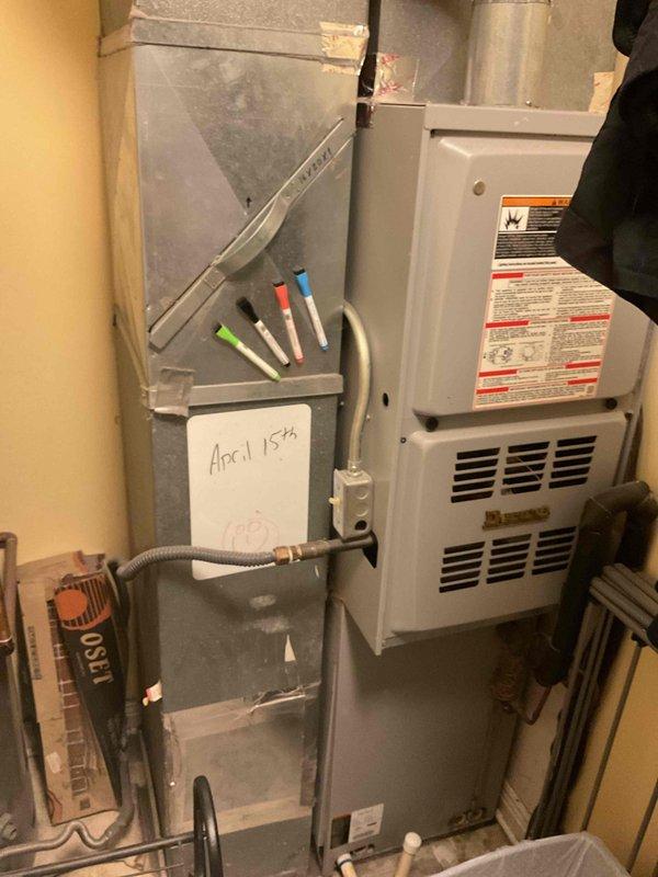 # HVAC System Evaluation and Replacement Estimate

Responded to service call for air conditioning system not cooling adequately. Upon arrival, evaluated a 10-year-old residential HVAC system consisting of a forced-air furnace with integrated cooling capabilities located in the utility area. Performed comprehensive assessment of the existing equipment, which showed signs of age-related decline in cooling performance while maintaining partial heating and cooling function. Documented current system configuration including gray metal furnace unit with standard ductwork connections and ventilation components. Photographed equipment specifications, manufacturer labels, and overall installation layout for estimate preparation. Based on system age, declining performance, and inspection findings, provided detailed replacement estimate to homeowner outlining options for new high-efficiency HVAC equipment installation to restore full cooling capacity and improve energy efficiency.