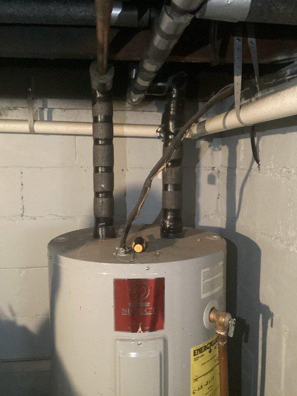 Completed annual tanked water heater maintenance as part of Bronze service plan. Performed full system flush to remove sediment buildup, inspected all connections and fittings at tank top including supply lines and relief valve, and verified proper operation of heating elements. Delivered replacement nano anode rod for corrosion protection and dropped off battery charger for customer equipment. All plumbing connections, PVC discharge lines, and brass fittings inspected and found secure with no leaks detected. Water heater operating within normal parameters upon completion.