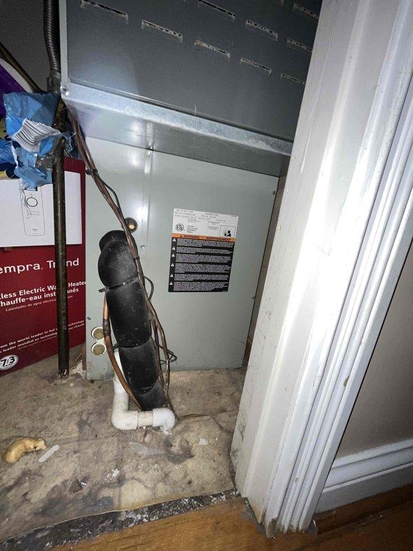 Performed on-site evaluation of existing 15-year-old Trane air conditioning condenser unit and matching furnace system for complete HVAC replacement estimate. Inspected outdoor condenser unit located on brick paver pad against exterior wall, assessed electrical disconnect and utility connections, and documented current system configuration. Evaluated indoor air handler and furnace installation in basement utility area, reviewed existing ductwork connections, and photographed equipment specifications for accurate replacement system sizing and proposal development.