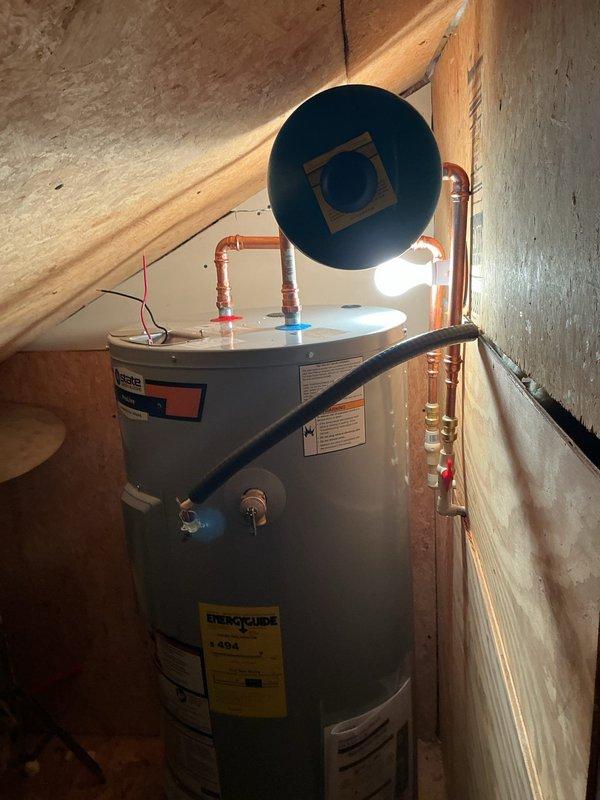 Successfully completed installation of a State Industries ProLine water heater in an attic space. The installation included proper venting with flue pipe connection, copper supply line connections with shut-off valves, and all necessary safety labeling in accordance with manufacturer specifications and local plumbing codes.