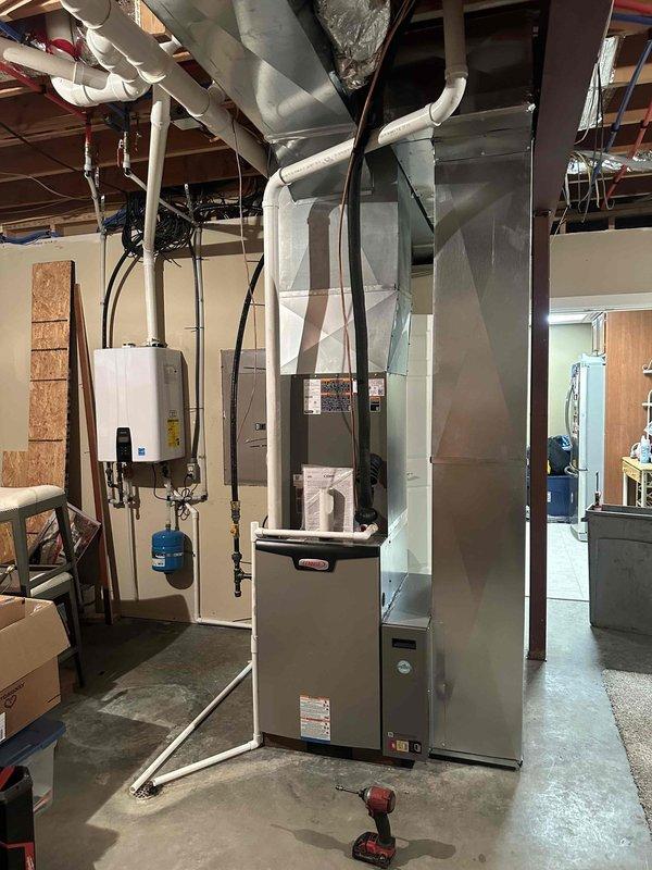Completed full HVAC system installation in residential basement, including new 4-ton furnace unit with 18 SEER cooling capacity and 99% AFUE heating efficiency. Installed complete ductwork system with insulated metallic plenum and distribution branches throughout basement ceiling joists. System includes proper electrical connections, condensate drainage via PVC piping, and integration with existing utility infrastructure. All components tested and operational upon completion.