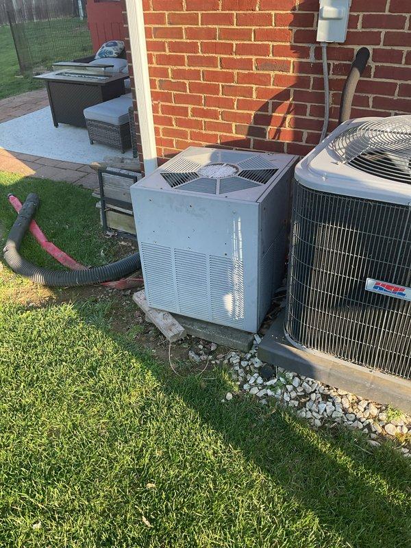 Conducted comprehensive estimate for replacement of 22-year-old HVAC system in residential property with tight utility closet installation. Evaluated existing King brand vertical furnace unit with associated ductwork, gas line, and condensate drain configuration. Assessed outdoor condensing units positioned on gravel pads alongside brick exterior, including existing Trane equipment. 

Recommended 2.5-ton two-stage system to optimize cooling performance for main foyer and rear two bedrooms, which were identified as priority zones. Evaluated existing flexible and rigid ductwork routing, including tan flexible ducts and gray corrugated runs connecting to furnace cabinet. Documented gas line configuration, electrical connections, and PVC condensate drainage system for replacement planning. Photographed current equipment layout to develop installation strategy for confined closet space with multiple utility connections. Provided Green tier, A+ rated estimate addressing system capacity requi